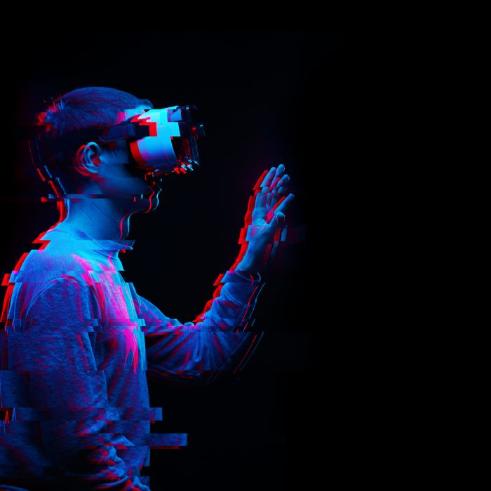 Man is using virtual reality headset. Image with glitch effect.
